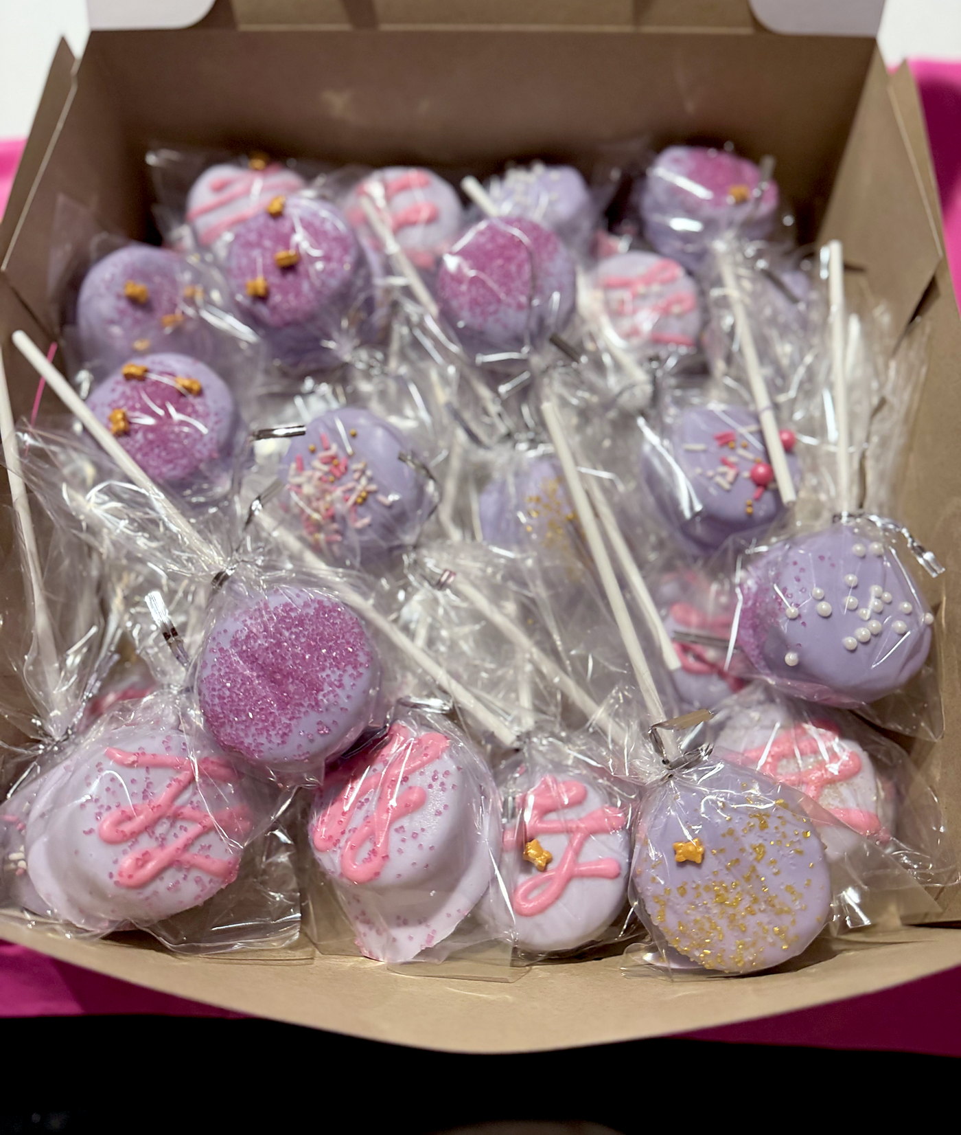 Pale blue cake pops with pearl sprinkles for a baby shower