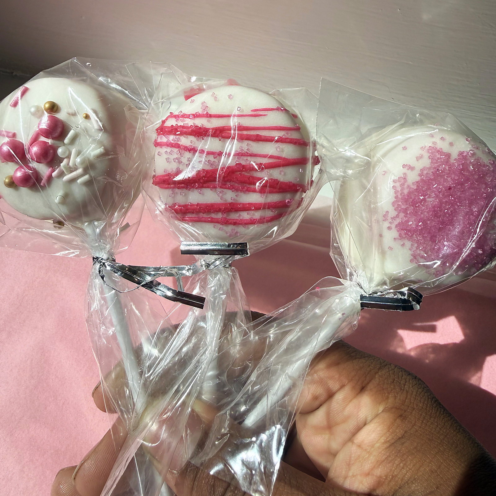 Cake pops in pink, gold and blush, wrapped and tied