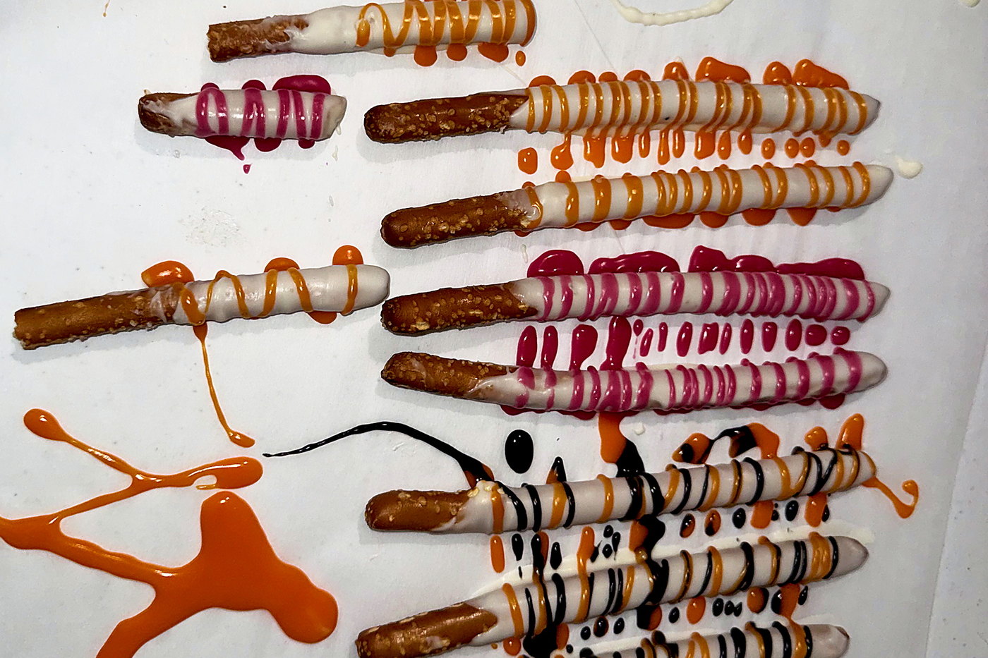 Pretzel rods drizzled in party colors