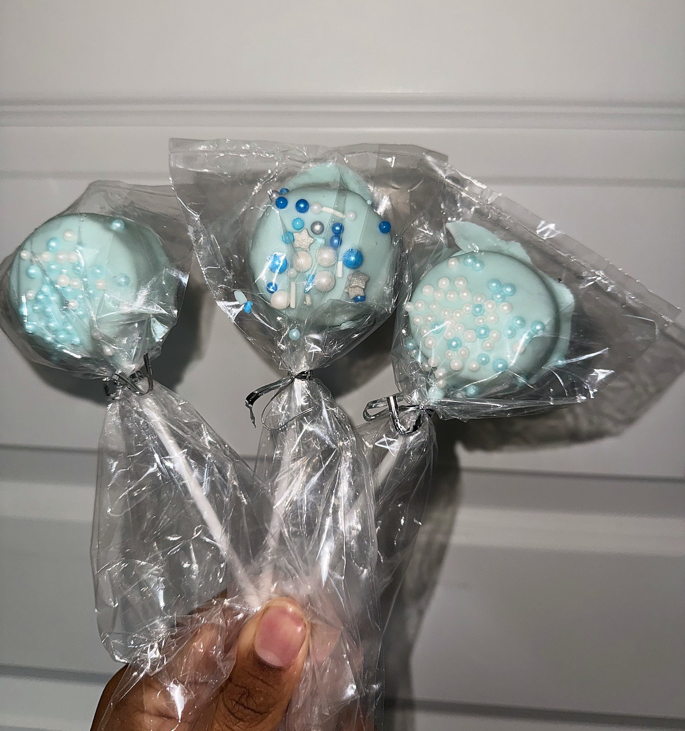 Lavender cake pops with pink drizzle, boxed for a birthday party